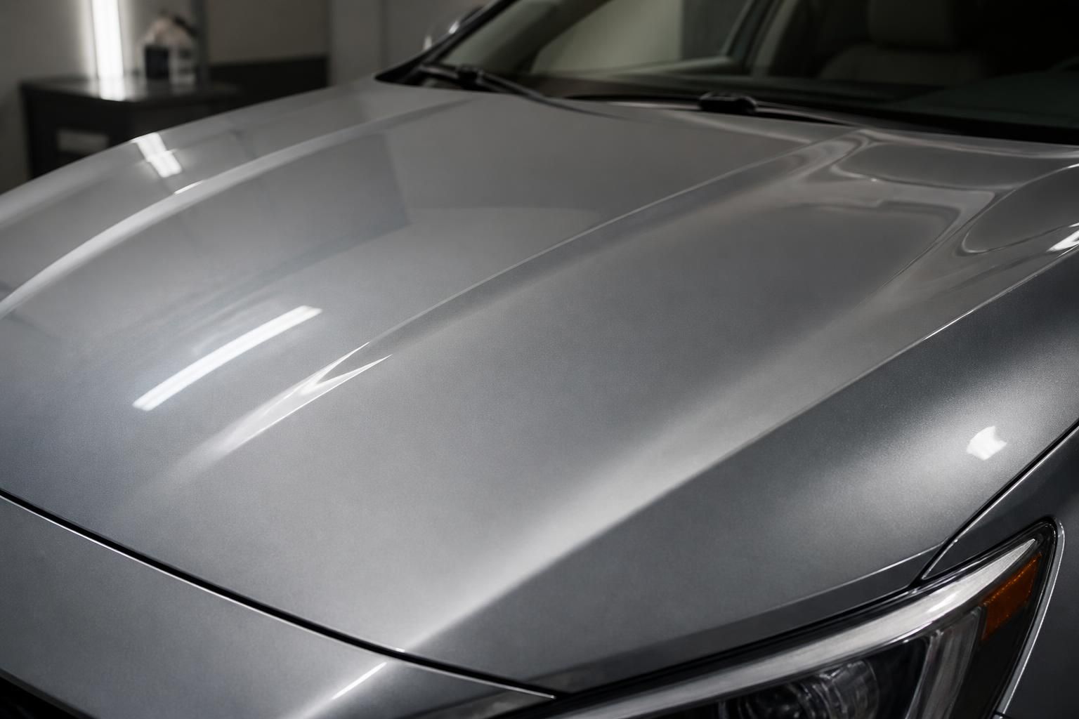 Wax-protected car hood with smooth reflections and even finish.